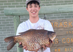 State record holder holding a massive goldfish