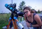 Girl looking through a telescope