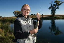 Young woman holds up a fish she caught at Fort Robinson's Grabel Ponds