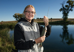 Young woman holds up a fish she caught at Fort Robinson's Grabel Ponds