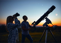 People using telescopes to look at the night sky