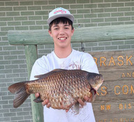 Dylan Frye holding a state record goldfish 