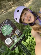 Girl standing next to a Your Parks Adventure selfie sign