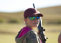 Girl competing in the Nebraska Youth Smallbore Silhouette Invitational pauses for a picture.