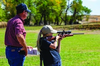 Girl shooting a rifle at a youth competition