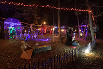 A Nebraska state park campsite at night, decorated for Halloween with lights