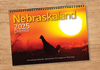 The cover of the 2025 Nebraskaland Calendar showing a silhouette of a bird at sunrise