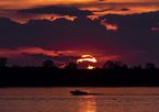 Silhouette of a boat at Sherman Reservoir as the sun sets