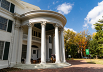 The exterior of Arbor Lodge Mansion in fall, with large white pillars