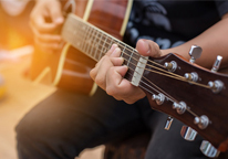 Closeup of someone strumming a guitar