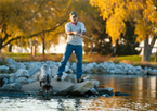 Man fishing at Fort Robinson State Park with vibrant fall color in the background