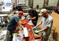 Fisheries biologists remove scales and otoliths from captured bluegills as part of a study.