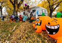 Kids trick-or-treating at a Nebraska state park campsite decorated for Halloween