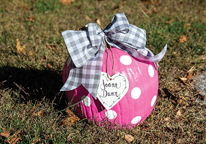 A memorial pumpkin painted pink and decorated for the Pink Pumpkin Walk