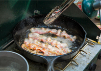 Cooking bacon on a liquid gas fueled camp stove