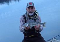 Daryl Bauer holds up a saugeye he caught late last fall.