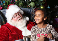 Girl smiling and sitting with Santa at Mahoney State Park