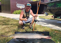 Brenden Jones poses alongside his rod and reel state record gar.