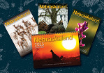 Spread of Nebraskaland Magazine covers and the 2025 calendar on a holiday background