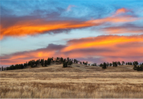 A colorful winter sunset above the Ogalala Grasslands and the Pine Ridge.