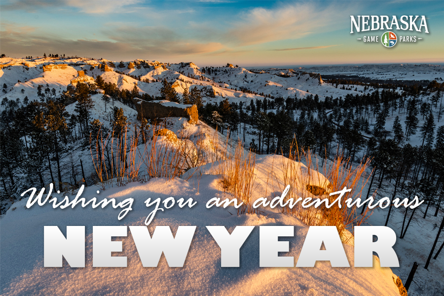 A snowy bluff at a Nebraska state park, with text: "Wishing you an adventurous new year."