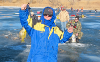 Person making a thumbs-up during an ice-fishing clinic