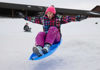 A girl sledding at Mahoney State Park.