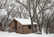 A cabin at Platte River State Park in winter, with snow around it