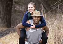 A couple hiking piggyback-style in winter at Mahoney State Park