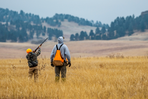 A boy and dad hunt pheasants together