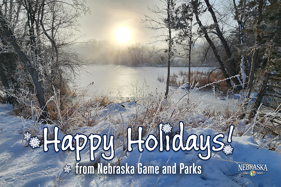 A scenic winter image with text: "Happy Holidays from Nebraska Game and Parks"
