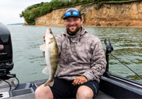 An angler holds up a walleye on Lewis and Clark Lake