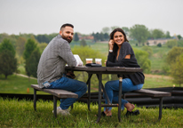 A man and woman sit at a picnic table during Sip Nebraska.
