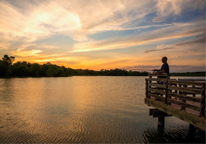 A person fishes from a dock.