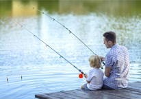 Father and son fishing from a dock
