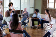 Group meeting with participants sitting on chairs in a circle