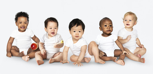 Diverse babies sitting on floor