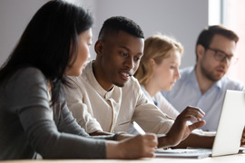 Students looking at a laptop