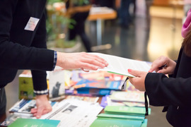 Hands at an information table