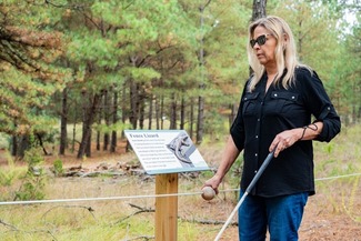 Woman utilizing accessibility features on trail