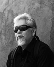 Levi Romero black and white image of a man in sunglasses