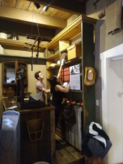 Two students holding up a sign for an exhibit in the GHH mercatile replica room