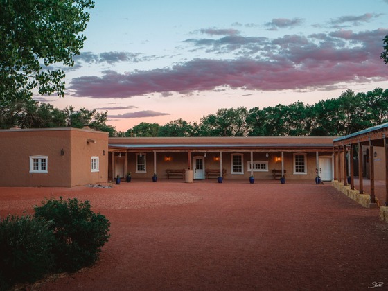 Image of an adobe building at sunset.