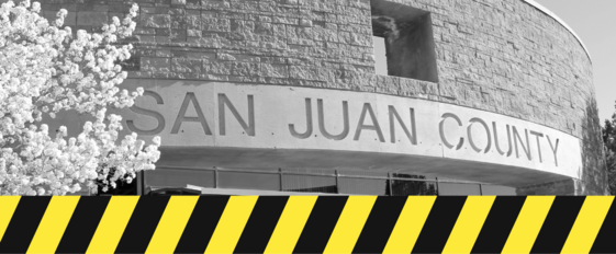 photo of San Juan County administration building with illustration of caution tape