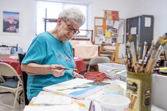Connie Medina painting at her local senior center