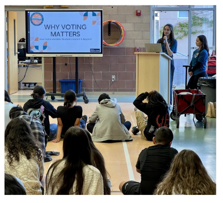 Clerk staff members presenting to a group of kids