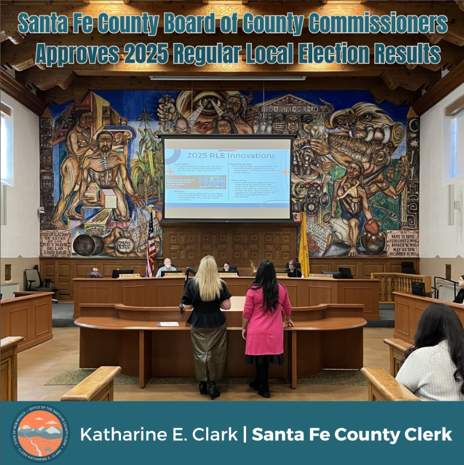 Picture of Clerk Clark and Deputy Clerk Ortiz presenting the results of the election to the Board of County Commissioners 