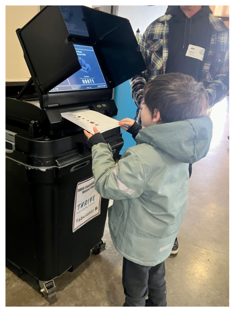 THRIVE student casting mascot ballot at a tabulator