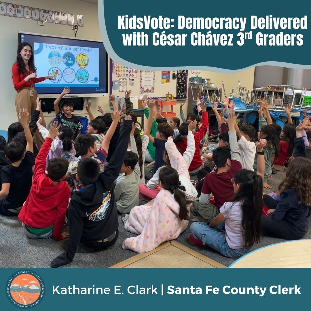 Clerk's Office staff member giving a presentation to a group of students sitting on the floor, all raising their hands