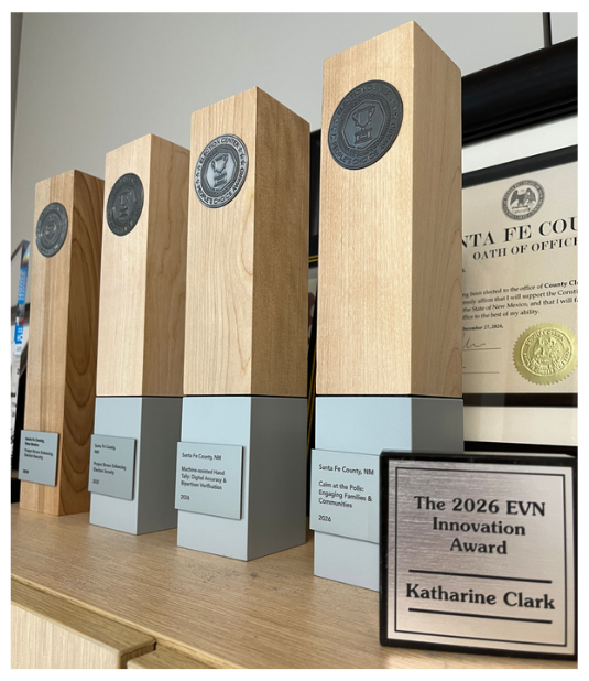 Picture of various awards on a shelf- EVN award is in the front